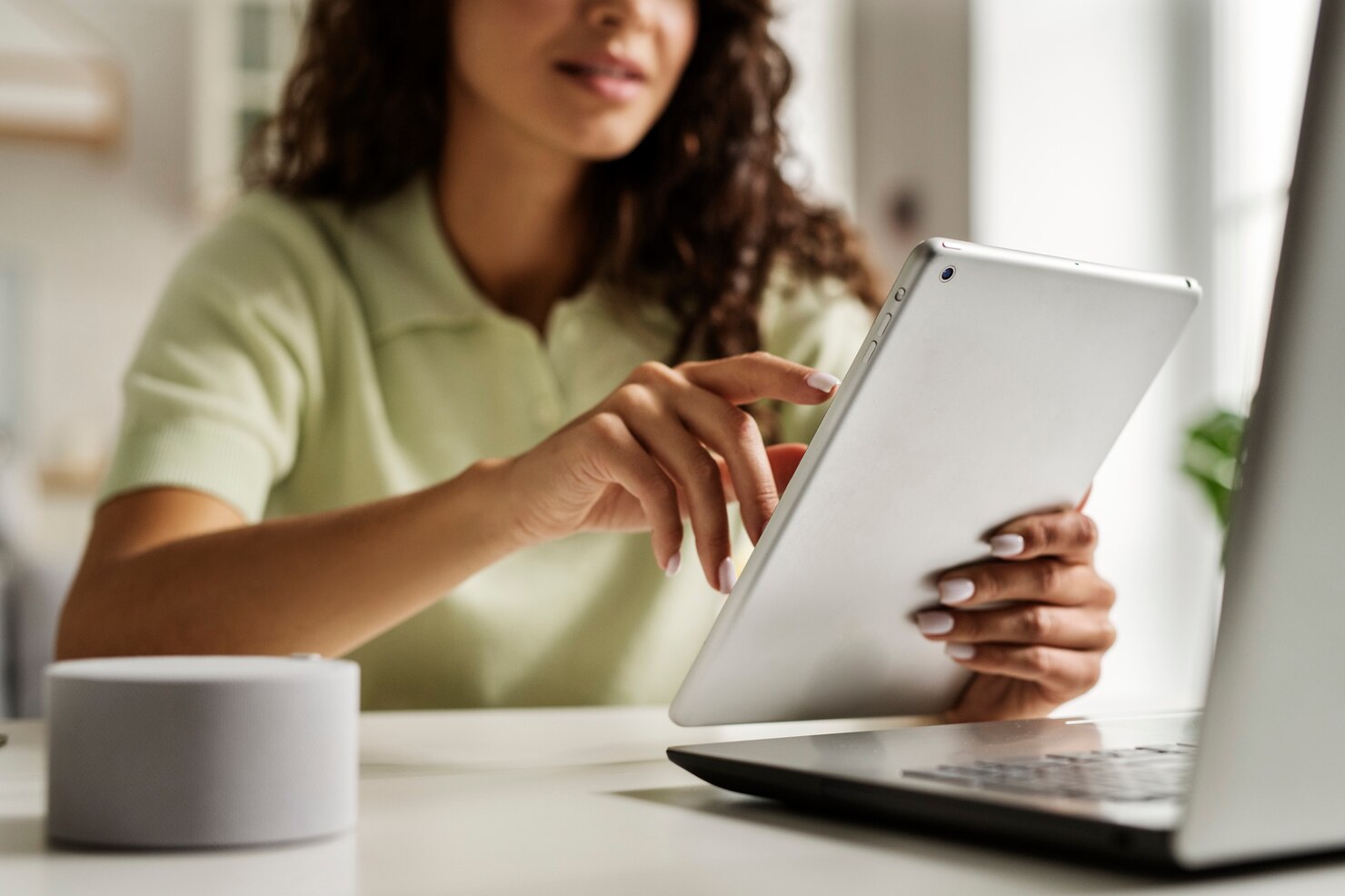 Front view woman holding tablet and creating a wishlist on a popular WooCommerce online shop. eCommerce stores with wishlists see higher conversions from website visitors