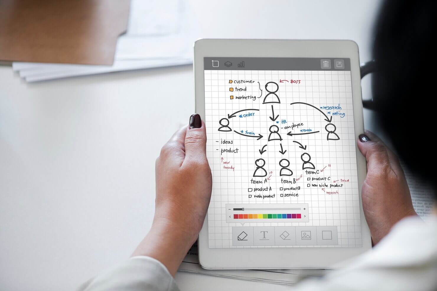 Businesswoman using tablet to decide on user roles and permissions