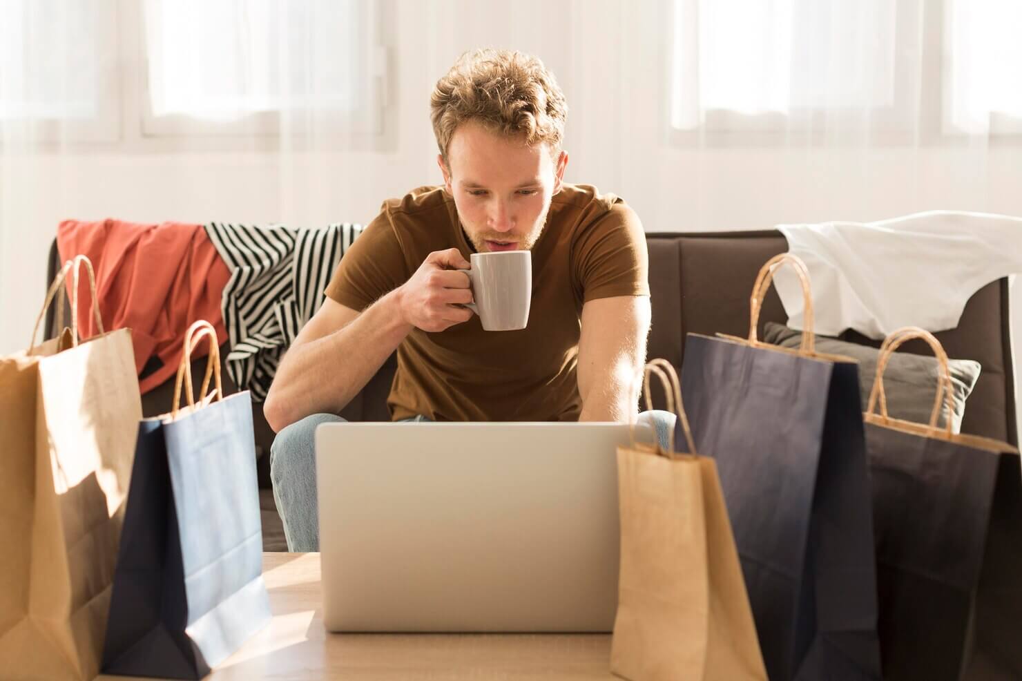 Man drinking coffee while shoppiing online. he is choosing the best payment gateway for him. Best WooCommerce payment gateways