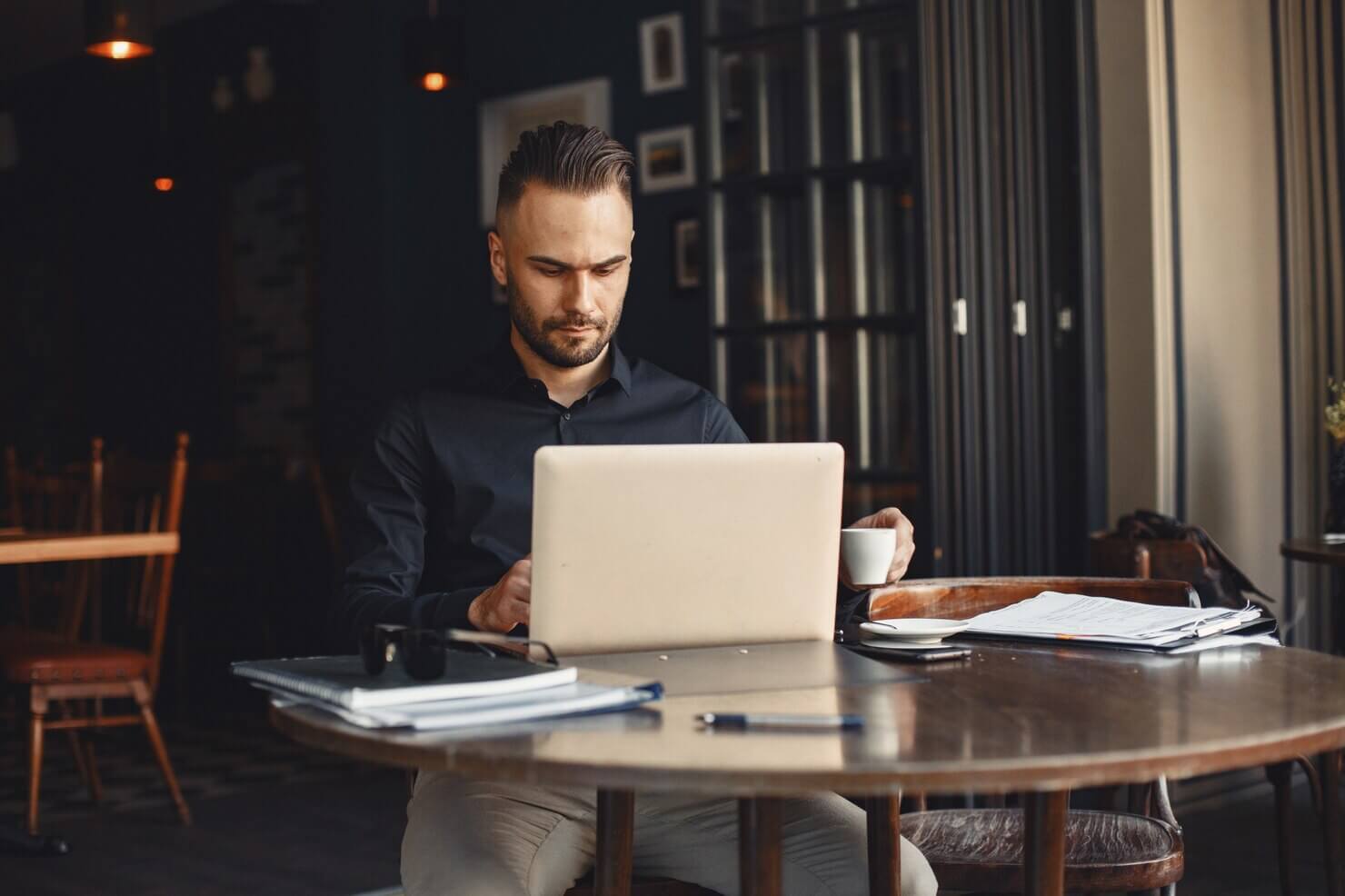 Man drinks coffee. Businessman reads documents.