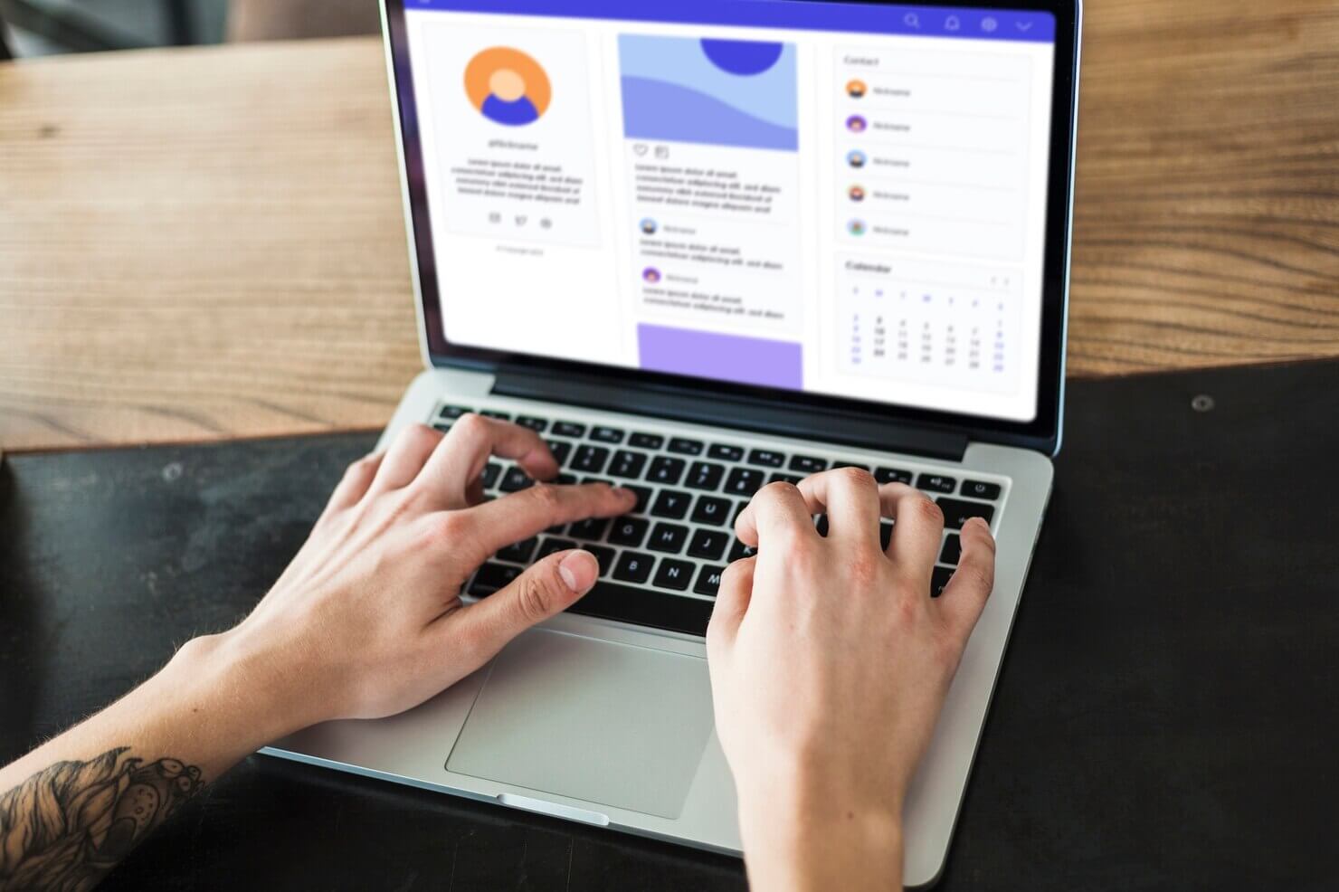 Person using laptop at table to work on website