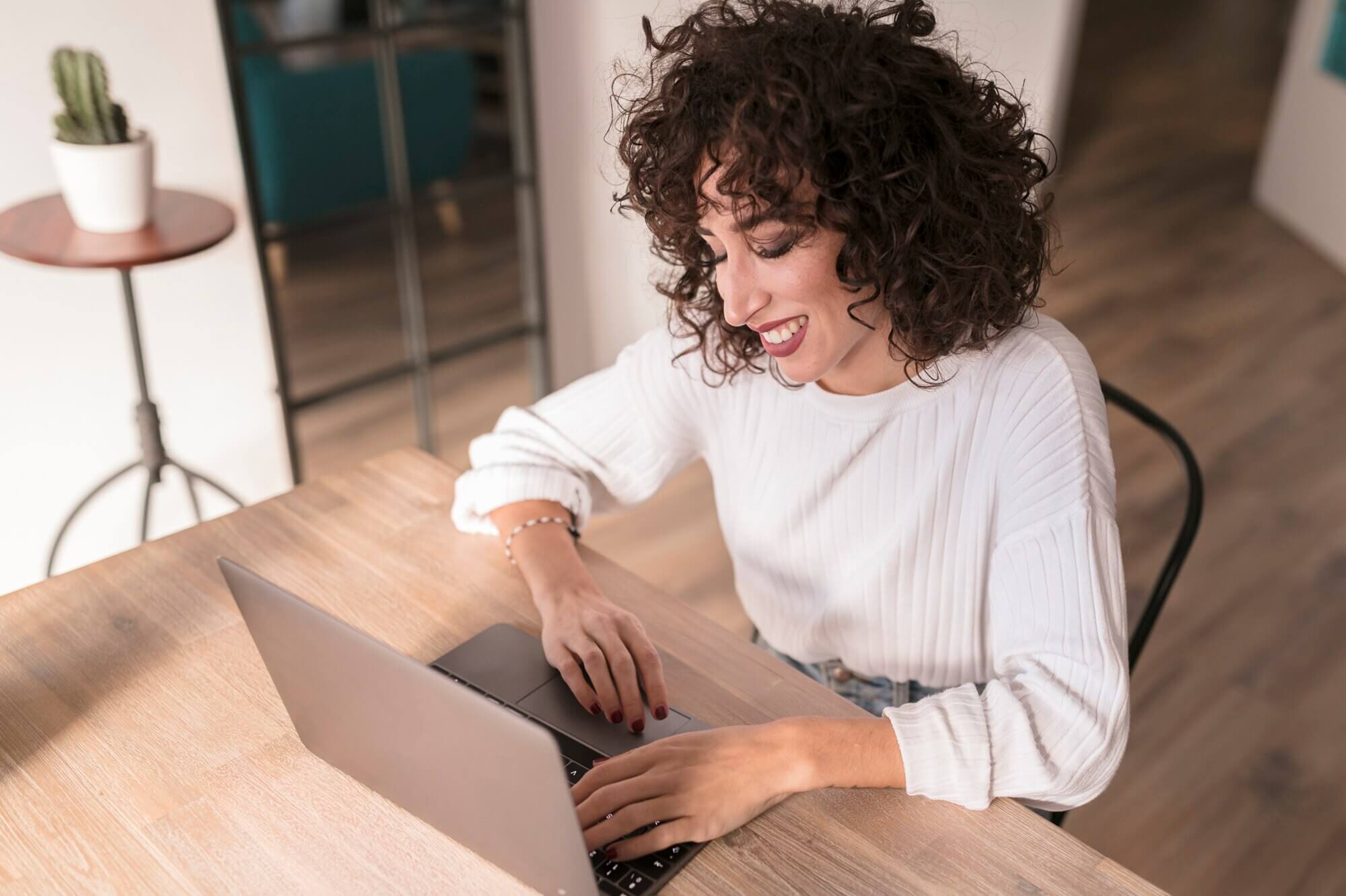 Girl with a laptop writing report about above the fold vs. below the fold for websites
