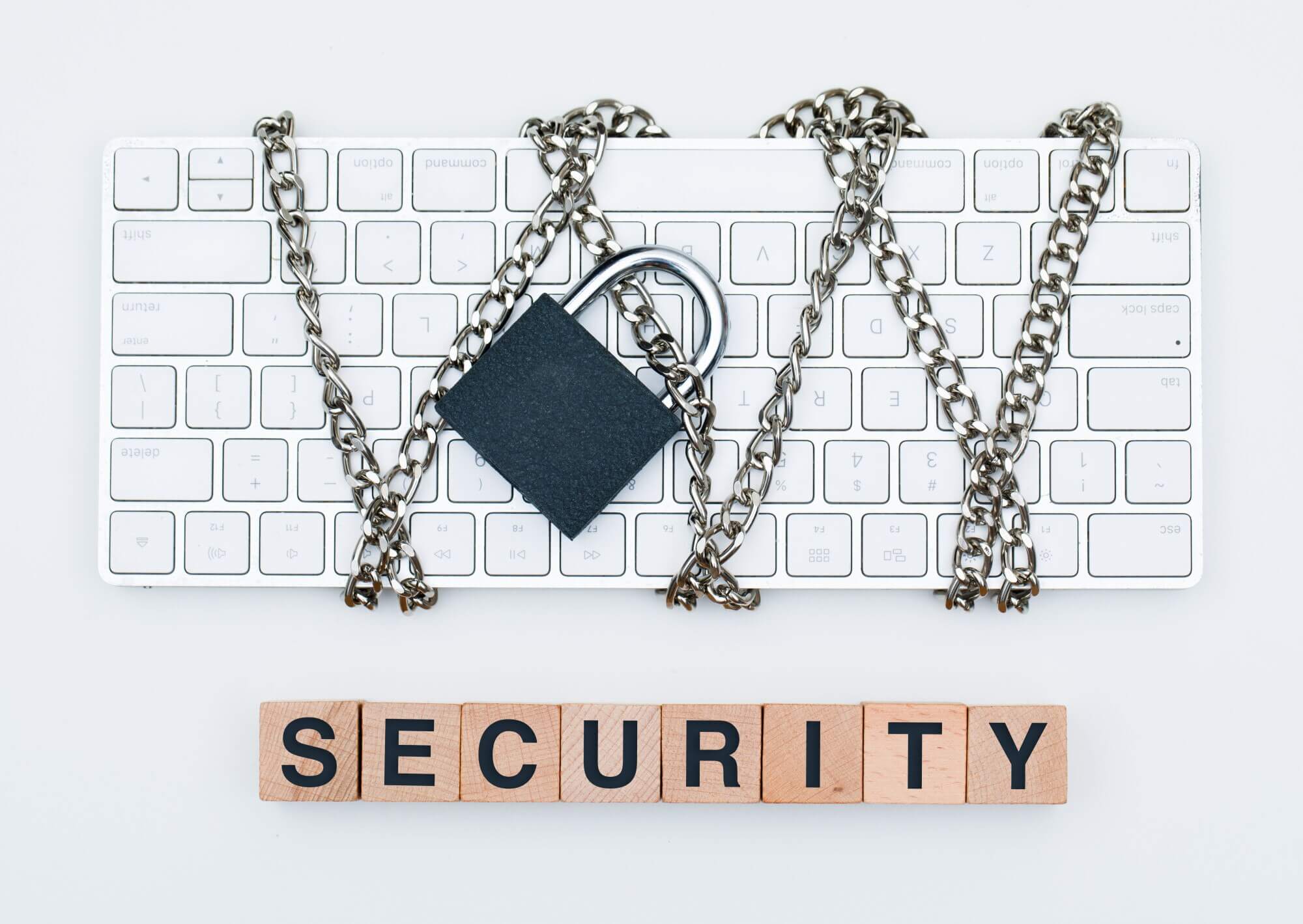 Security measures are part of 5-minute SEO & speed audit for WordPress. Lock and chain around white keyboard