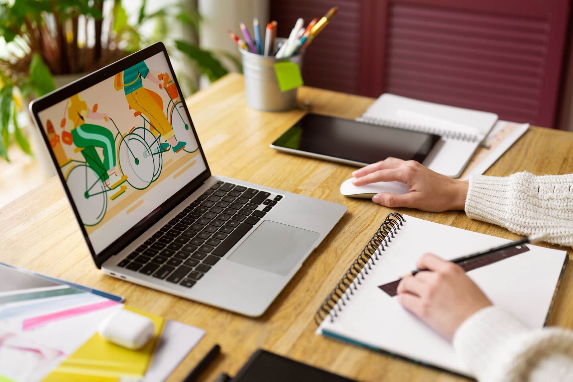 Creative illustrator working on devices to create a web design captivating for users