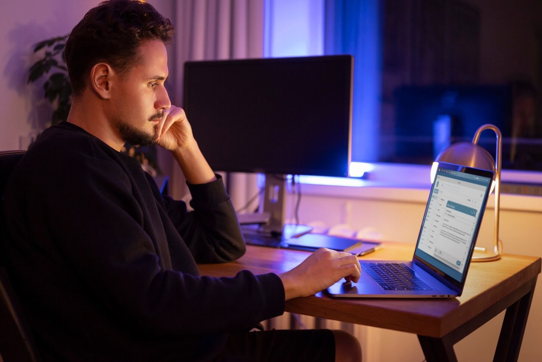 Person working late at night from home responding to emails about custom development