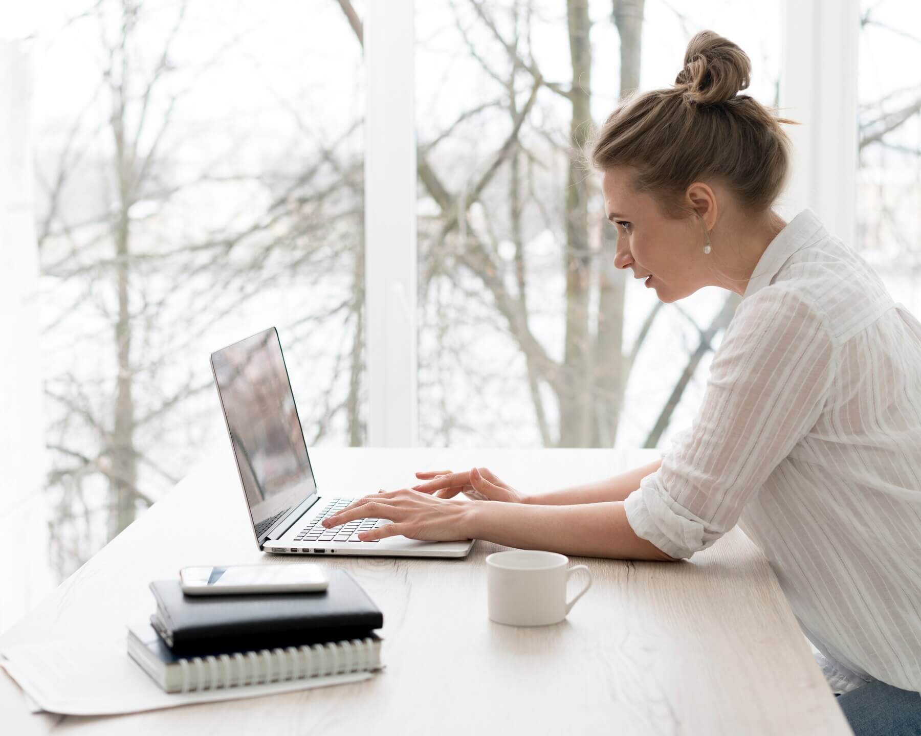 Woman working on laptop summing up various eye tracking tools for her website