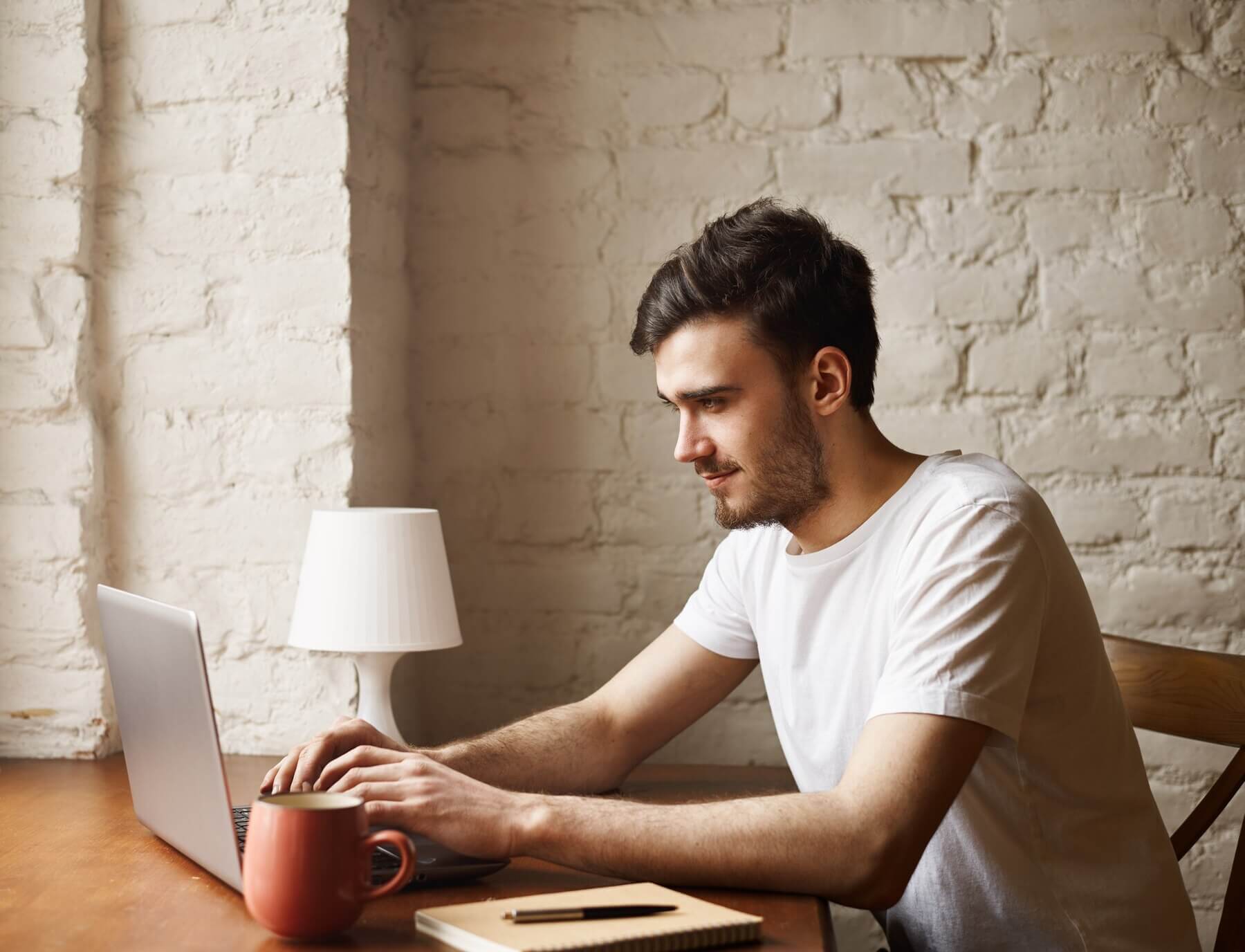 Man writing a report about insource or outsource WordPress support